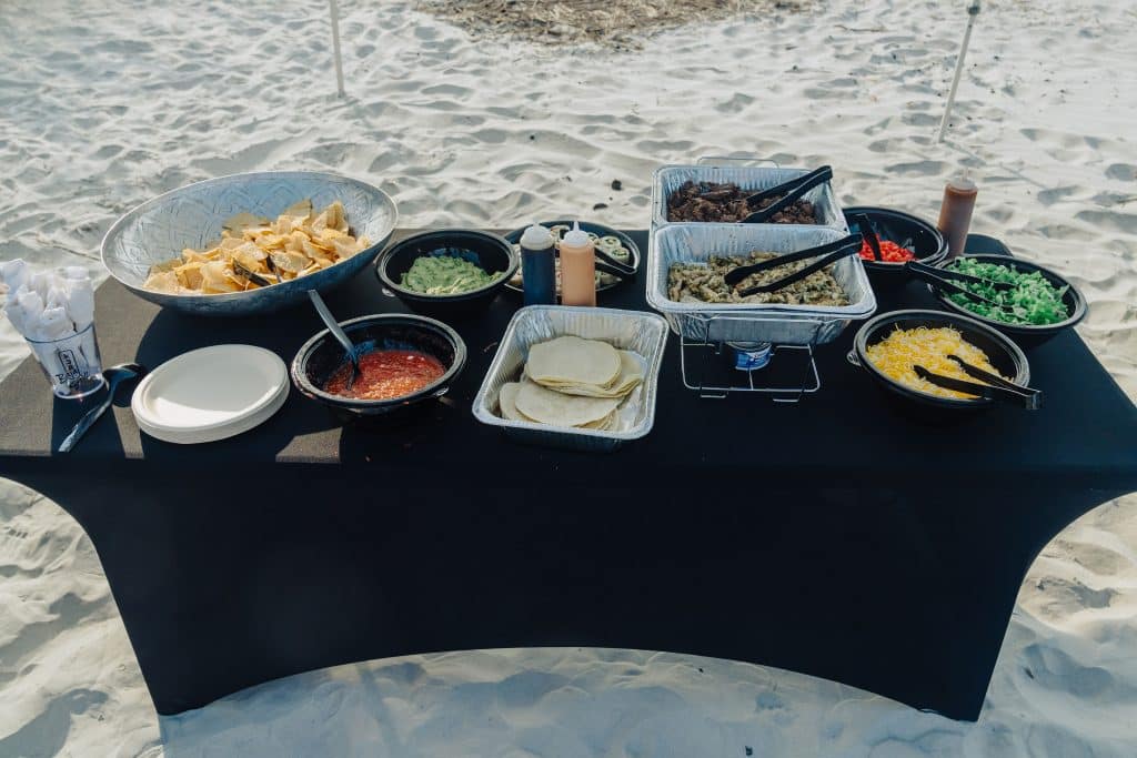 A Tower7 Catering spread served in the sand on the beach